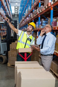 Warehouse manager interacting with male worker