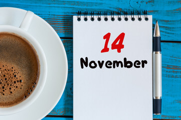 November 14th. Day 14 of month, morning coffee at cup with calendar on auditor workplace background. Autumn time, top view