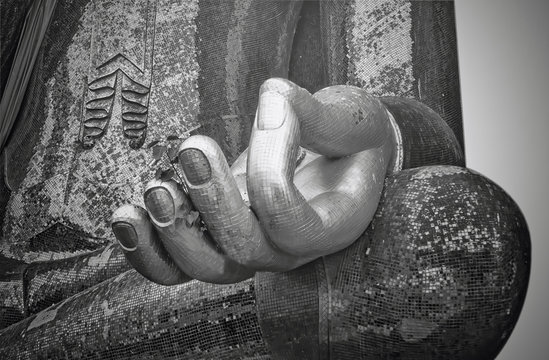 Buddha statue in Wat Si Chumi thailand, black and white focus at hand