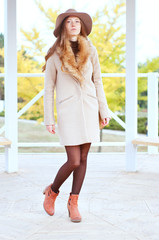 Elegant caucasian woman in fedora hat and coat