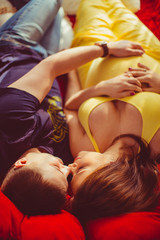 Young couple expecting a baby lying on the bed