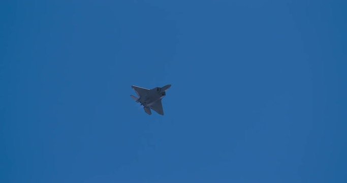 Tracking shot of F22 fighter jet flying in sky