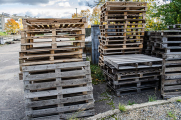 Wooden pallets / wooden pallet overlap in warehouse / stacked wooden pallets / Stacked wooden pallets at a pallet storage /