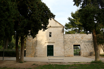 Fototapeta na wymiar Historic church and cemetery in park Sustipan. In Split, Croatia. 