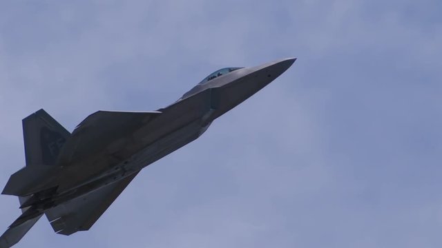 Slow motion of f22 fighter jet flying in sky