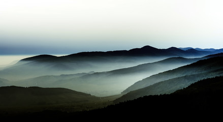Beautiful mountains landscape from the top of the hill with fog - 124252822
