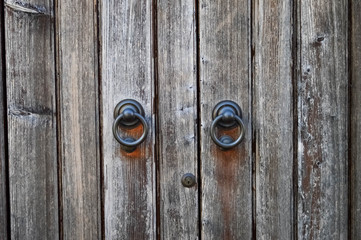 Old wooden gate with round iron handles