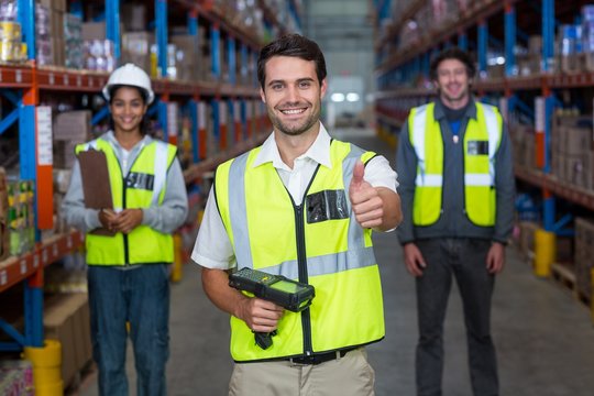 Warehouse worker showing thumbs up sign
