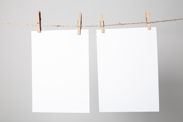 Blank poster hanging on rope with clothespins