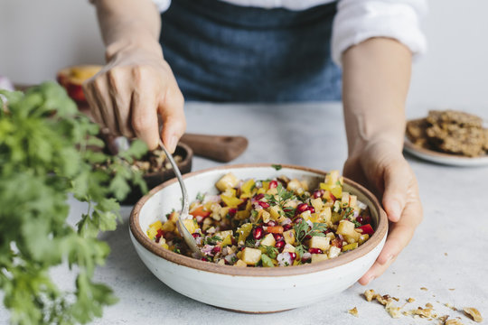 Woman mixing salsa in bowl