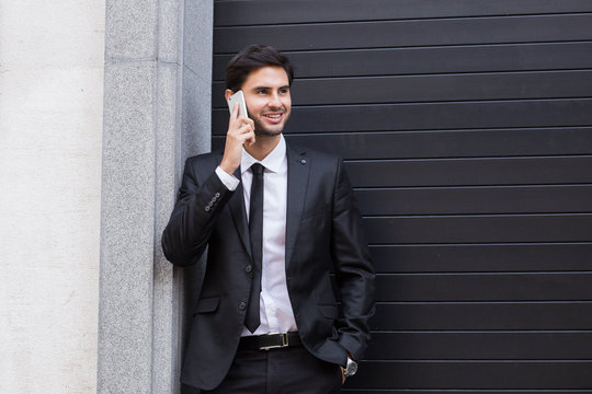 Handsome businessman talking on mobile phone
