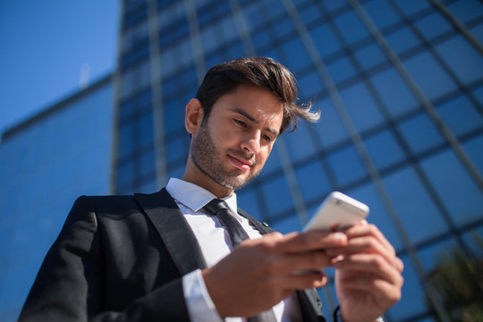 Handsome businessman using smartphone
