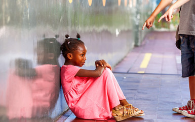 African girl mocked by school classmates, bullying concept