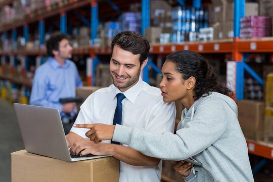 Warehouse worker working on laptop