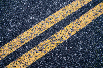 Fototapeta na wymiar Double strips lane road sign on asphault closeup