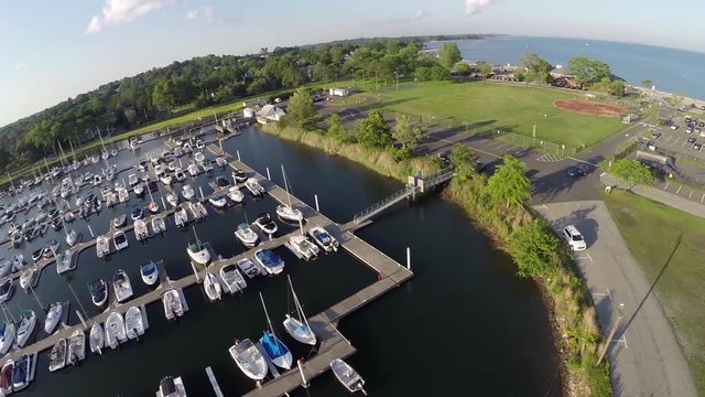 Aerials of a marina, baseball field and parking lot, shot at Compo Beach in Westport, Connecticut, USA.
