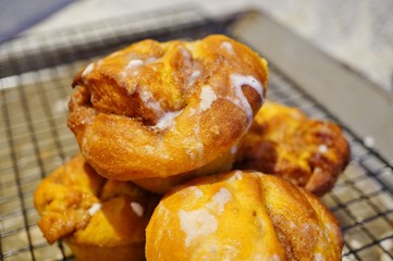 Pumpkin cinnamon rolls freshly baked in muffin tins