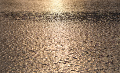smooth surface of the water at sunset