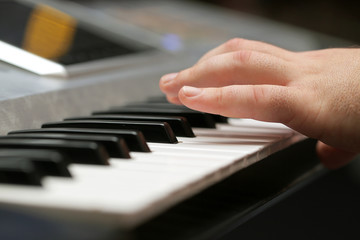 Fototapeta na wymiar hands of musician playing keyboard in concert