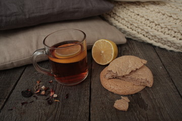 Fototapeta na wymiar comfort and tea with lemon and biscuits. winter and autumn are pleasantly warm tea.