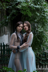 Two brunettes in elegant vintage dresses