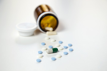 Medicine pills or capsules with syringe on white background. Drug prescription for treatment medication. Pharmaceutical medicament. Injection with vaccine