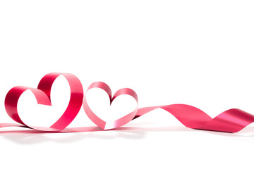 Ribbons shaped as hearts on white