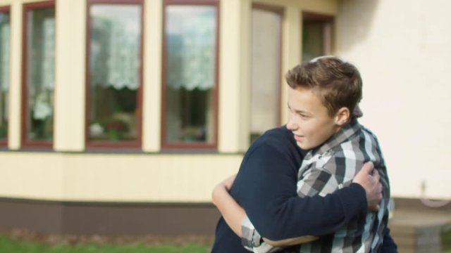 Grandson Runs Toward his Grandfather and Huggs Him