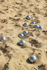 Fototapeta na wymiar Petanque balls on sand.