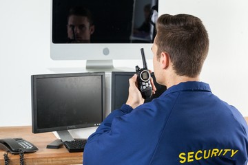 Security officer talking on walkie-talkie 