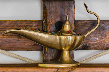 Old Aladdin's lamp standing on shelf created of the pallet