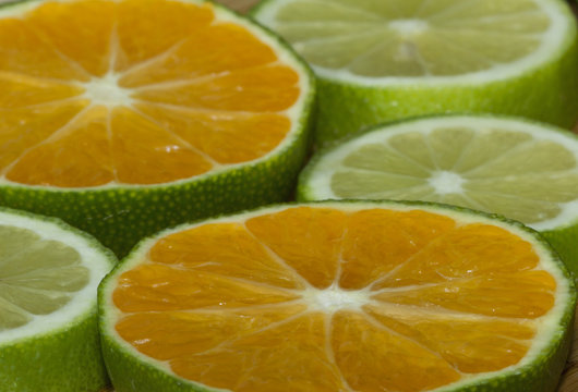 Slices of mandarin and lime on the cutting board