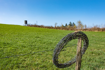 open barbed wire fence  on meadow