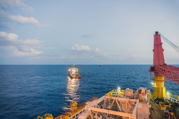 Anchor handling tug performing operation early in the morning at oilfield Malaysia