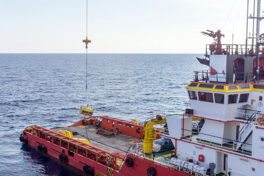 Anchor handling tug performing operation early in the morning at oilfield Malaysia
