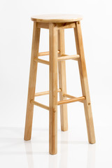 Wooden bar chair isolated on white background. Wooden light pine dining stool. Natural, solid wood bench.