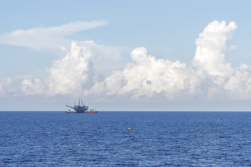 Anchor handling tug performing operation early in the morning at oilfield Malaysia