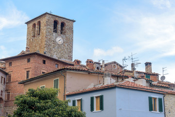 Fototapeta na wymiar houses and ancient clock tower, tuscany, italy