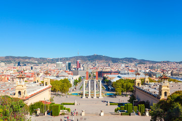 Fototapeta na wymiar Square of Spain in Barcelona with two Venetian towers in red brick and columns in the foreground, Plaza de Espana. Spain.