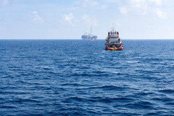 Fototapeta premium tugboat towing construction barge