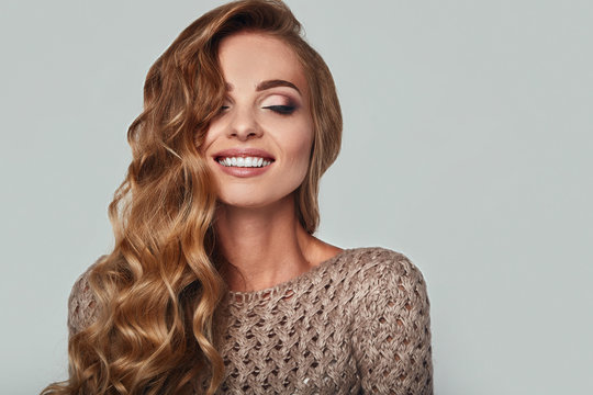 Portrait of beautiful smiling blond woman with long hair