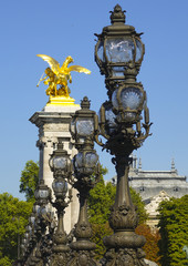 Fototapeta na wymiar The beautiful street lanterns and sculptures on Alexandre III Bridge in Paris - Pont Alexandre 3