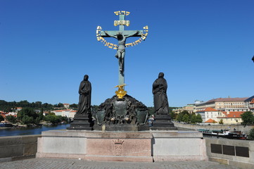 Fototapeta na wymiar Statue of the Crucifix and Calvary at Charles Bridge in Prague
