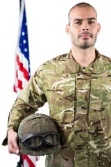 Portrait of smiling soldier standing with combat helmet