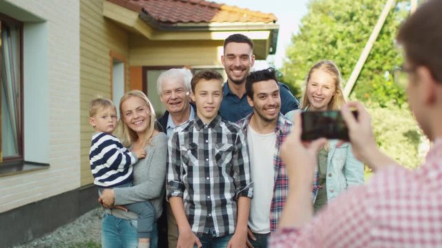 Man Taking Outdoor Photos of His Big Family.
