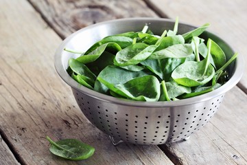 Fresh spinach on a rustic wooden table.Selective focus.