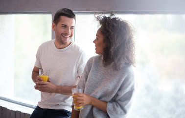 Young couple drinking juice and laughing together