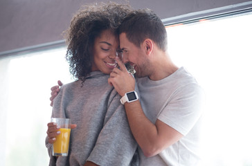 Smiling man touching the nose of his girlfriend tenderly