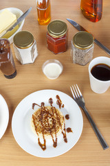 Freshly toasted crumpet covered in chocolate sauce for breakfast