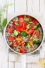 Warm quinoa and roasted vegetables salad on a rustic wooden table. Superfood concept.Selective focus